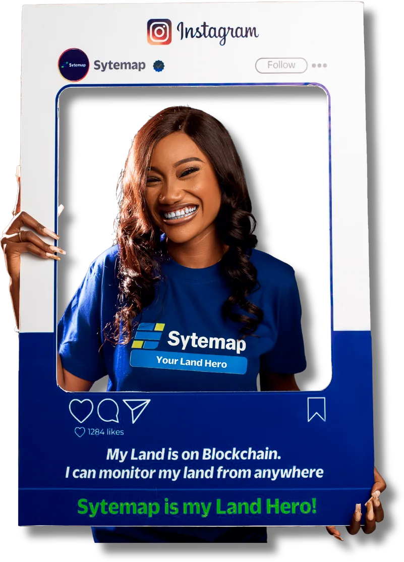 A smiling Sytemap landowner in a Sytemap T-shirt holding a frame that reads: My land is on blockchain. I can monitor my land from anywhere. Sytemap is my Land Hero!