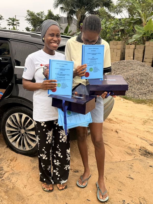 Two landowners holding their documents