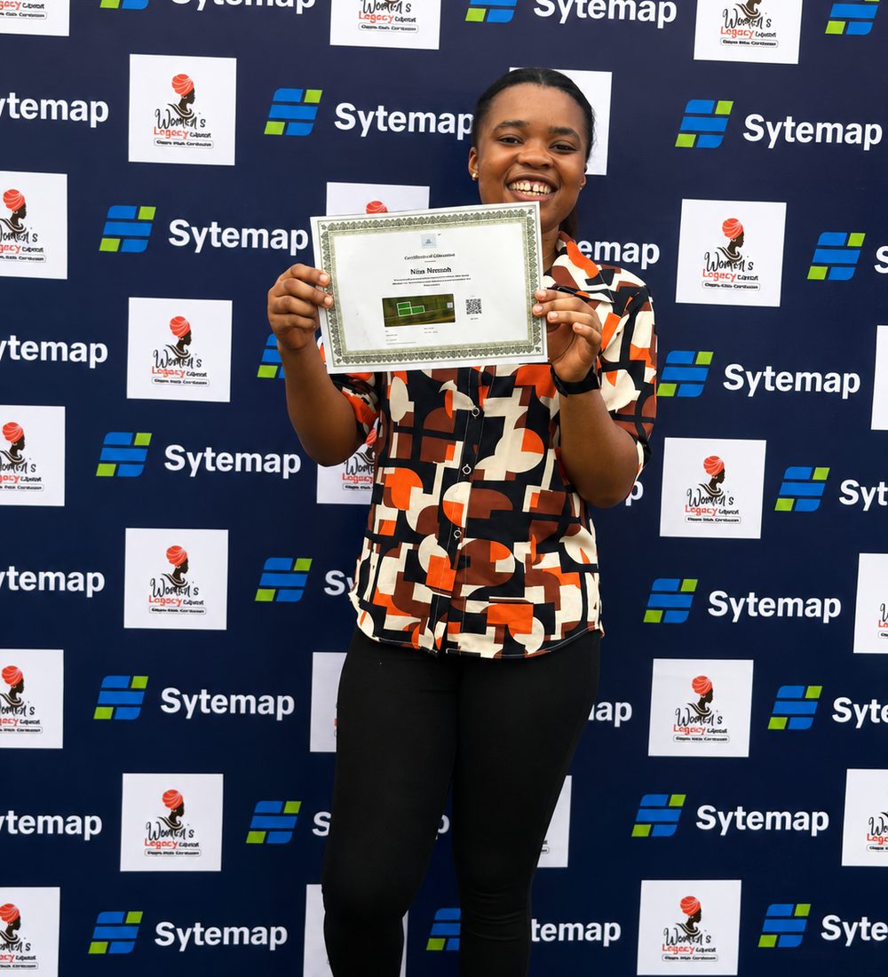 A Sytemap landowner smiling and holding up her Certificate of Allocation