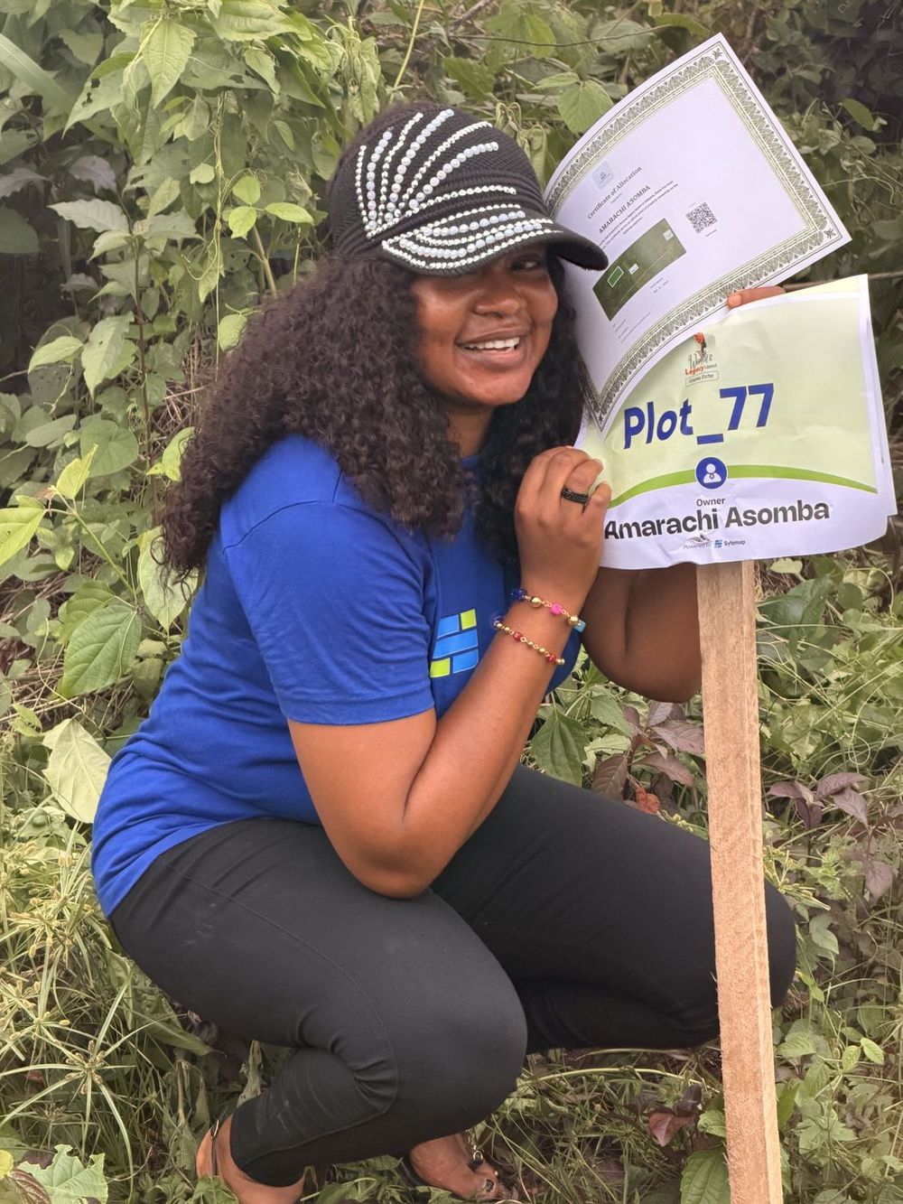 A landowner beside the marker on her plot