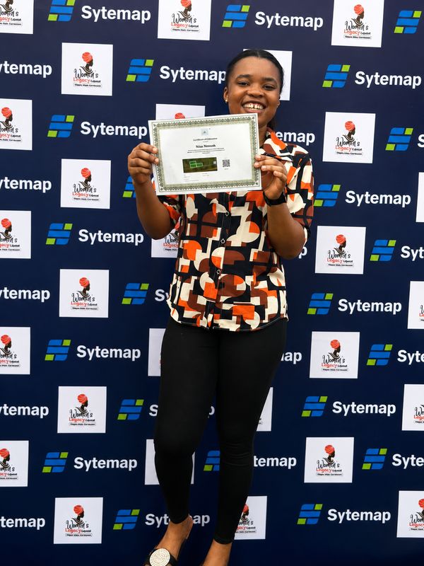 A landowner holding up her Certificate of Allocation