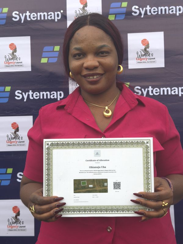 A landowner smiling with her Certificate of Allocation